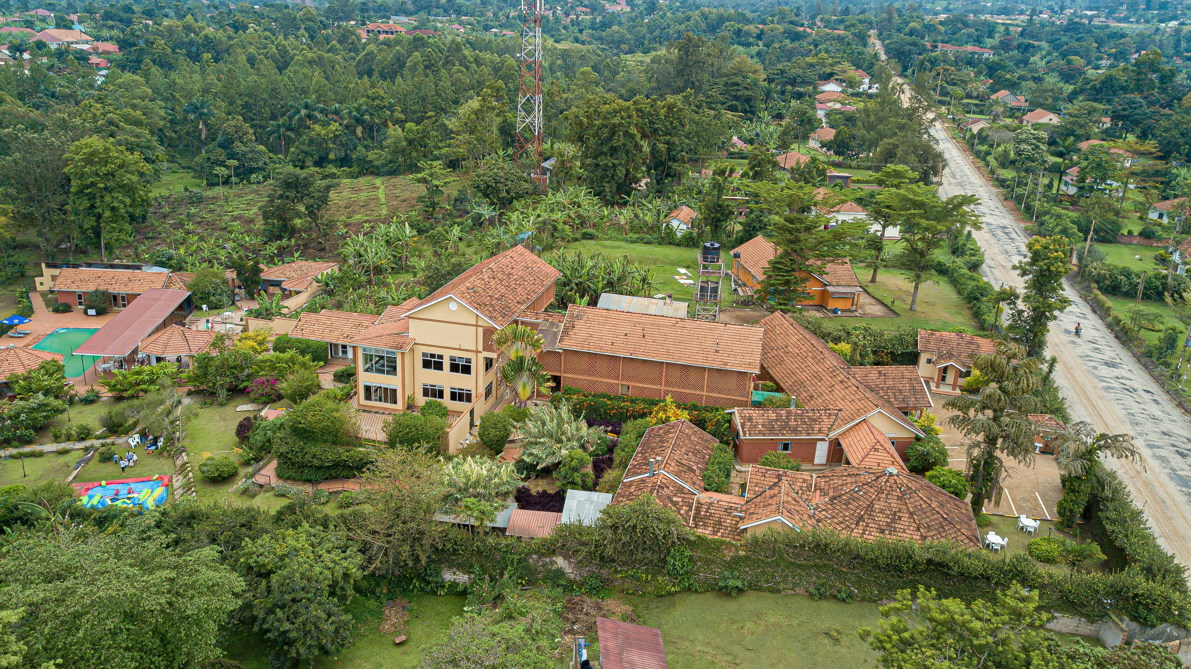 A residential area with houses, a road, and a large communication tower.