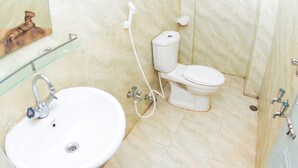 A bathroom with a white sink, toilet, and shower. - Jaintia Hill Resort (Gowainghat)