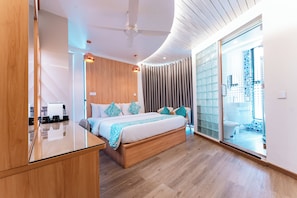 A modern bedroom with a wooden bed, a glass shower enclosure, and a view of the city.