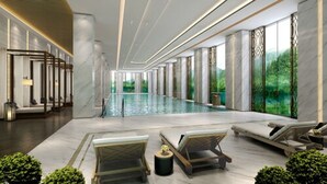 A modern indoor pool area with seating and a view of greenery. - PRIMUS Hotel Wuhan Hannan (Wuhan)