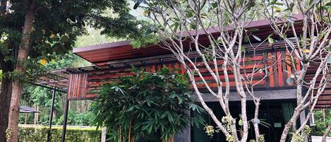 A modern building with a wooden facade and a covered outdoor area.