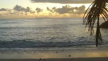 On the beach, white sand, sun loungers, beach towels