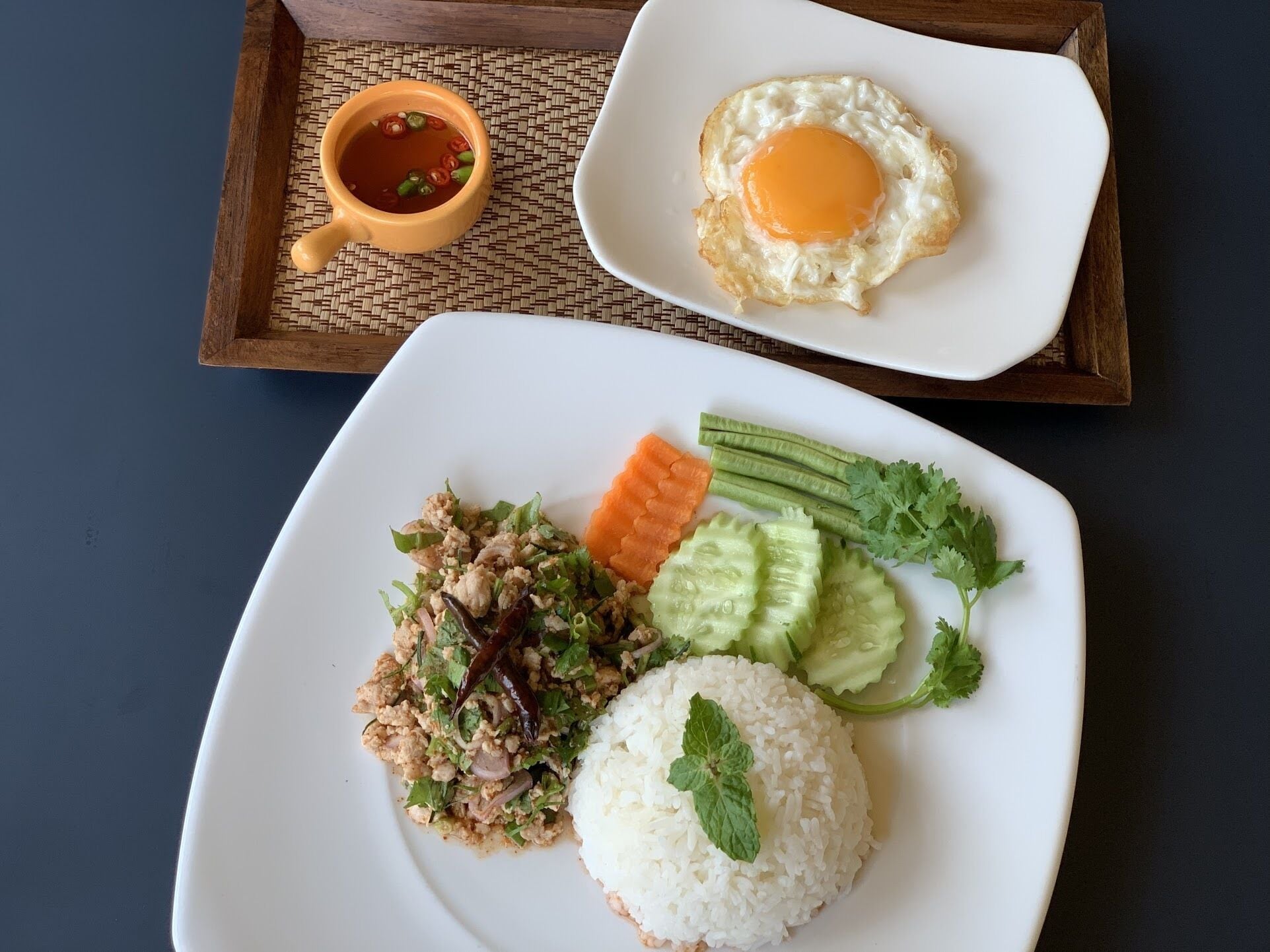 A plate of food with rice, vegetables, and a fried egg.