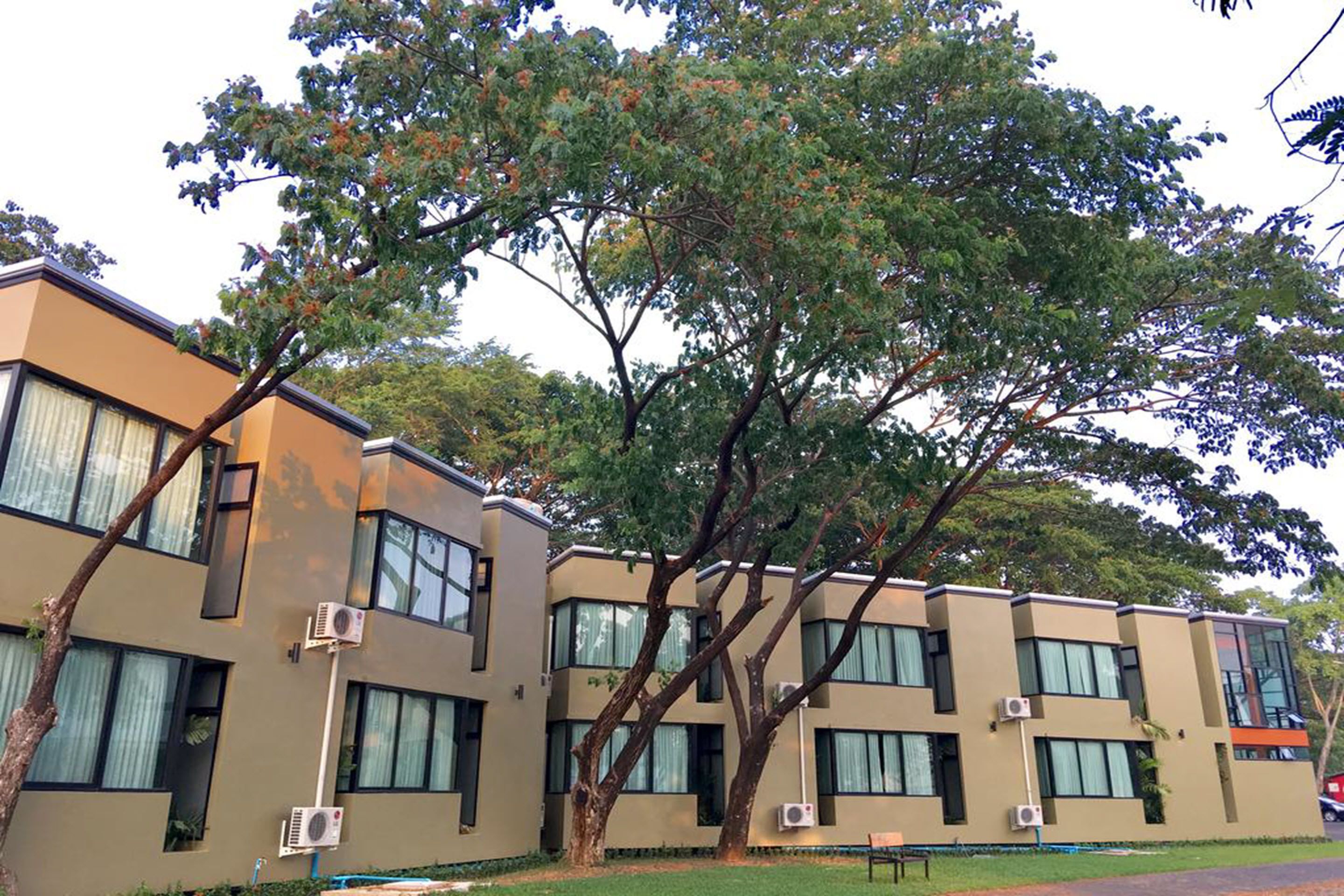 A modern building with multiple windows and air conditioning units.