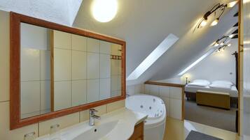 Deluxe Suite, 1 Bedroom, Jetted Tub, Garden View | Bathroom | Hair dryer, towels