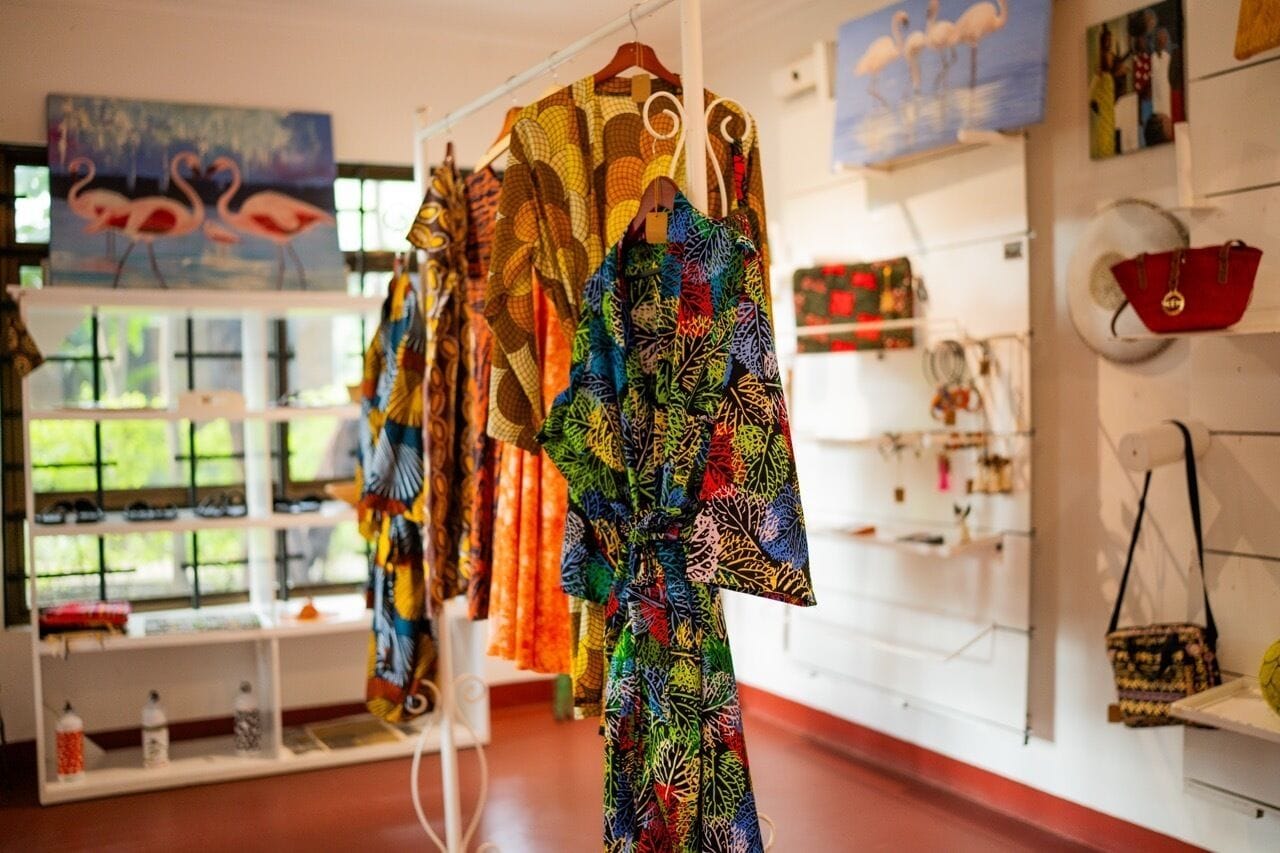 A boutique with colorful garments on display and a variety of accessories.