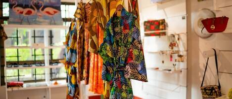 A boutique with colorful garments on display and a variety of accessories.