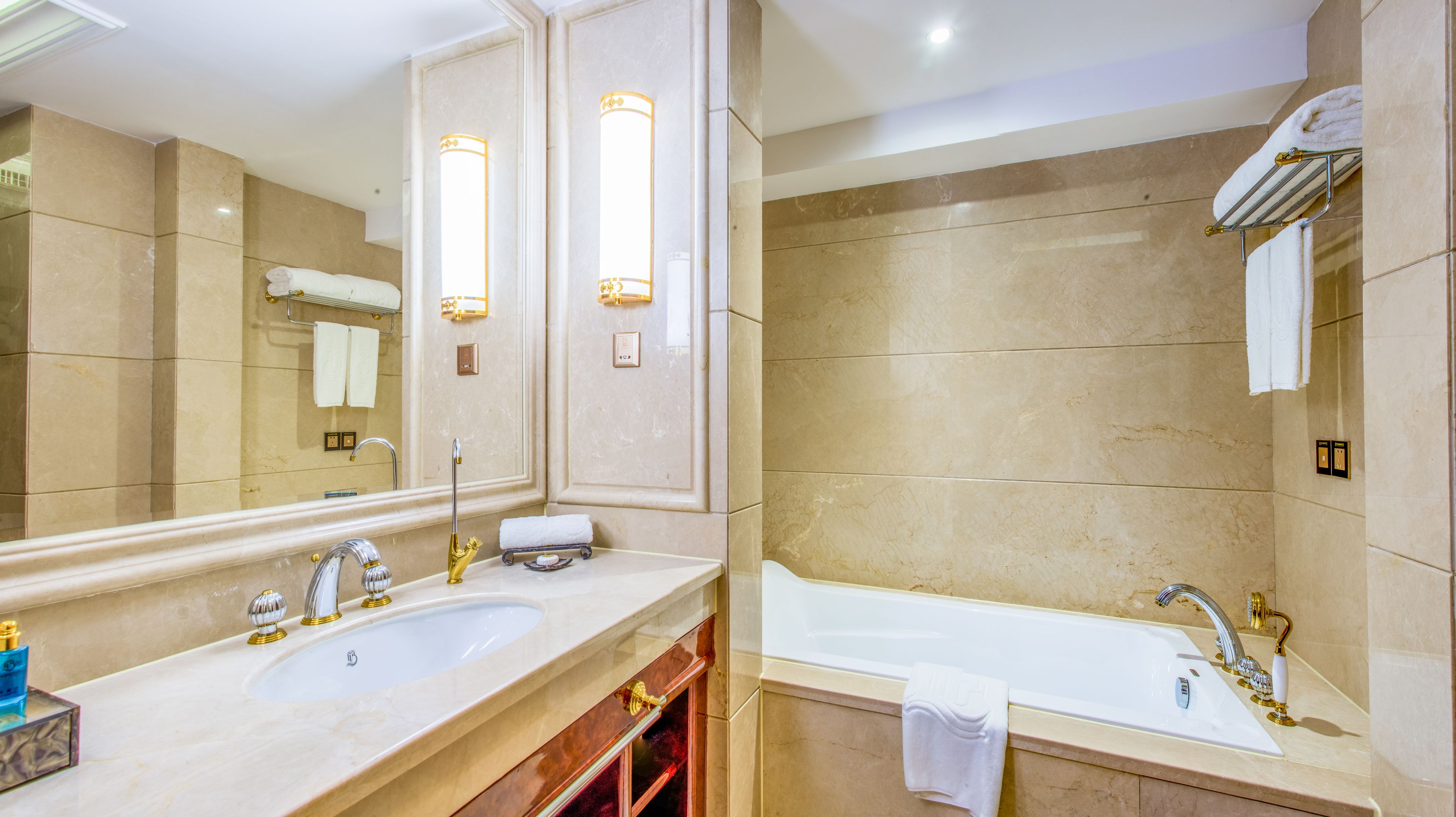 A bathroom with two sinks, a bathtub, and a large mirror.