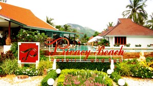 A resort with a sign reading "Privacy Beach," a swimming pool, and lush landscaping. - The Privacy Beach Resort & Spa (Sam Roi Yot)