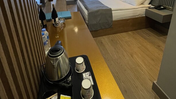 A modern hotel room with a bed, bedside table, and a view of the outdoors. - Sarikamis Aras Otel (Sarikamis)