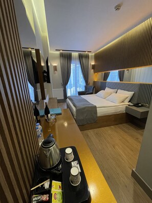 A modern hotel room with a bed, bedside table, and a view of the outdoors. - Sarikamis Aras Otel (Sarikamis)