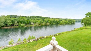A river with a grassy bank and trees. - Fort Taneycomo 2 Bedroom Condo by RedAwning (Branson)