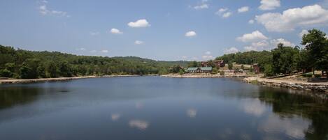 A serene lake with a small building in the distance.