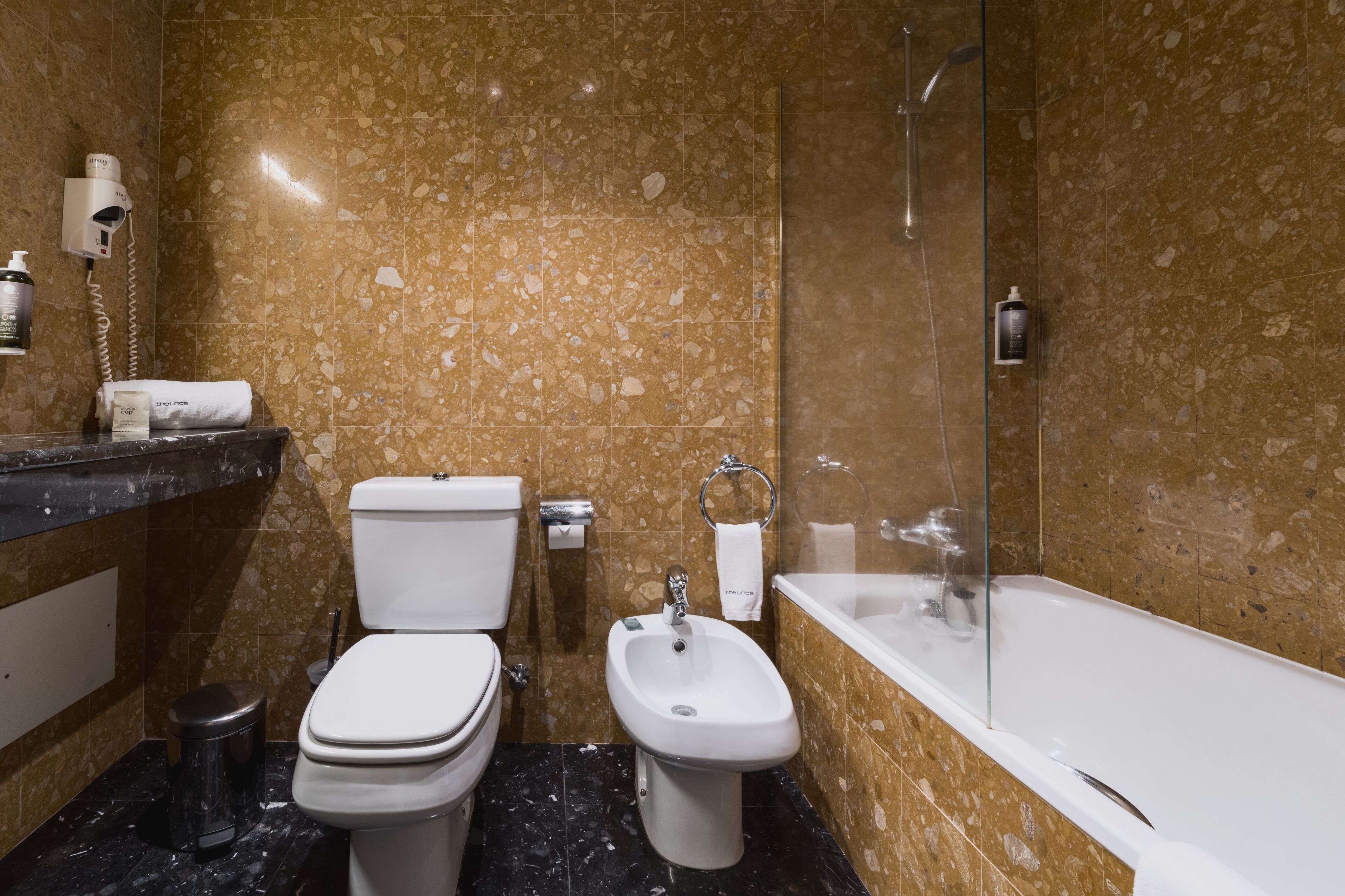 bathtub, free toiletries, hair dryer, towels