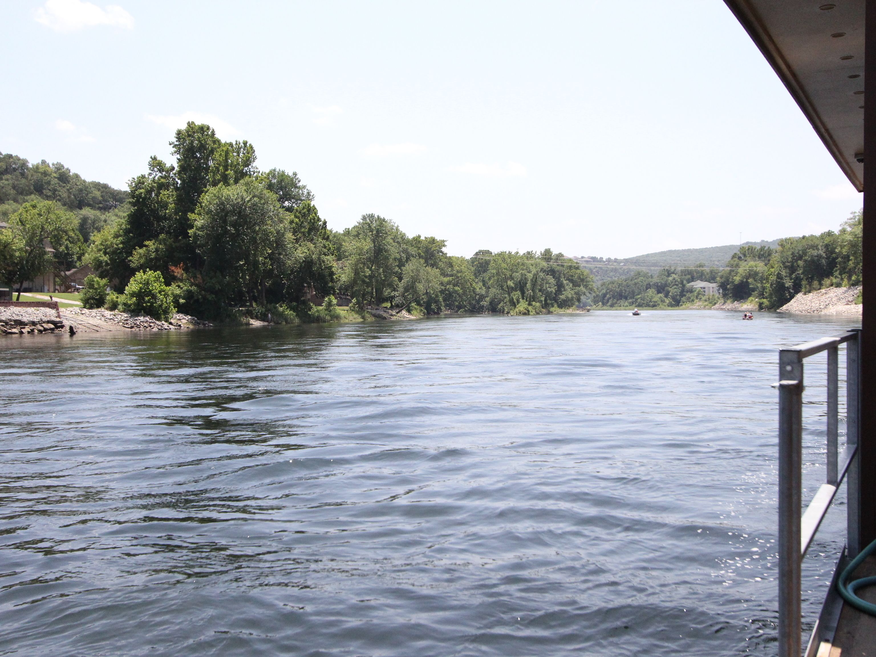A river with a wooden dock extending into the water.