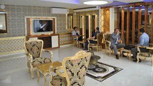 A lobby with ornate furniture, a television, and a decorative wall. - Hotel Star Park (Istanbul)