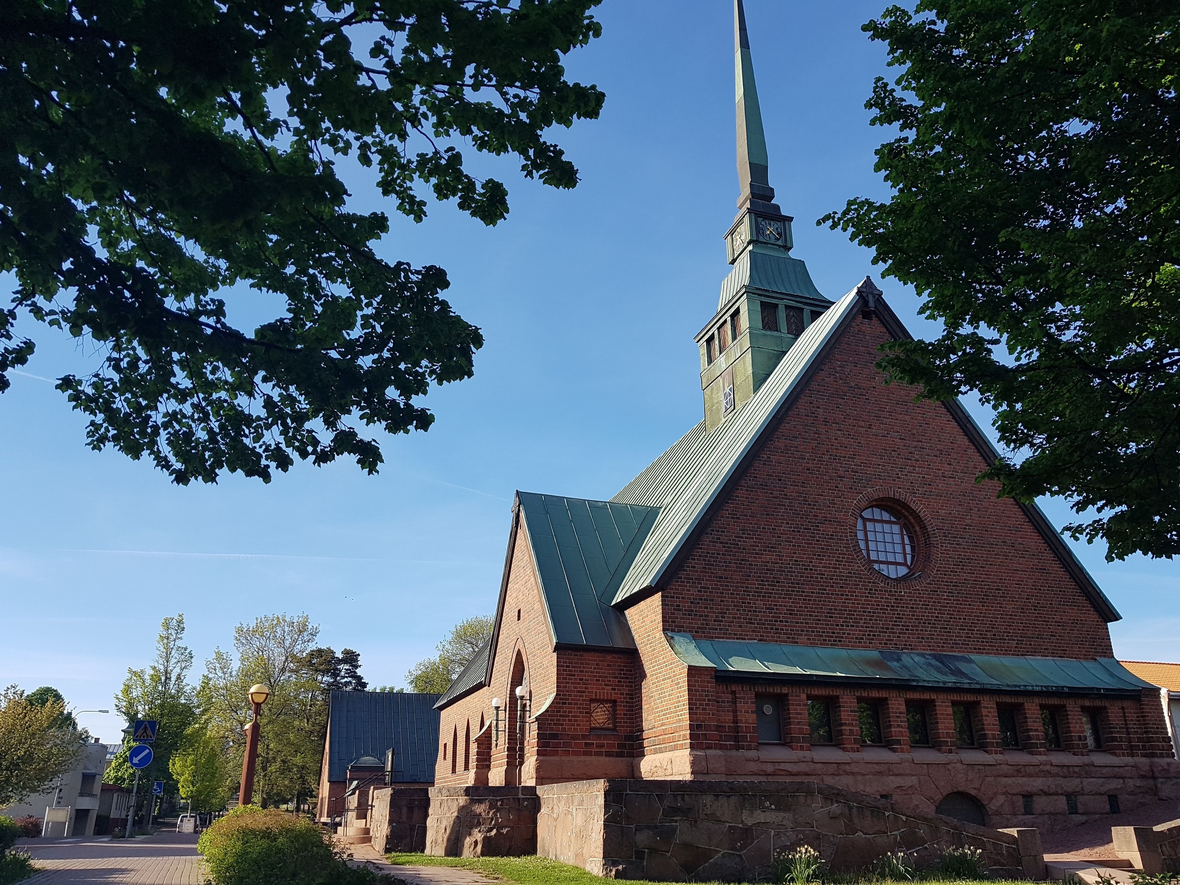 A church with a tall steeple and a clock tower.
