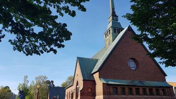 A church with a tall steeple and a clock tower.