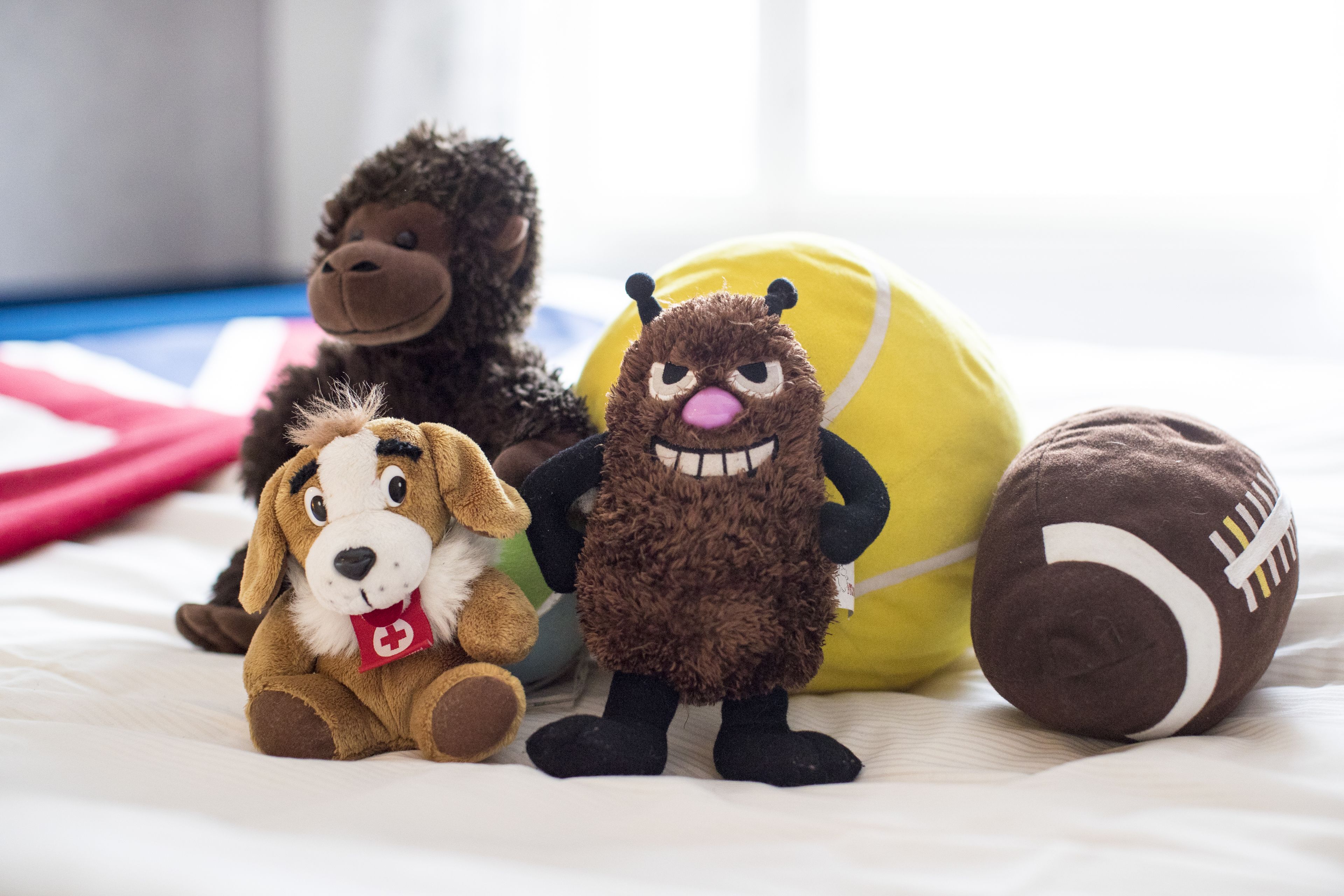 Plush toys on a bed.