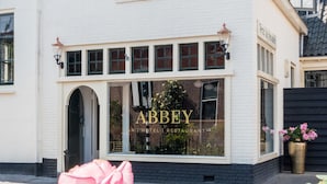 A white building with a sign reading "ABBEY HOTEL RESTAURANT". - Abbey Abcoude (Abcoude)