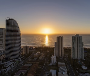 A cityscape with a prominent curved building and several high-rise structures. - Avani Broadbeach Residences (Broadbeach)