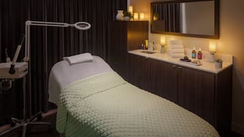 Cozy retreat with a neatly made bed, bedside table, and large mirror.