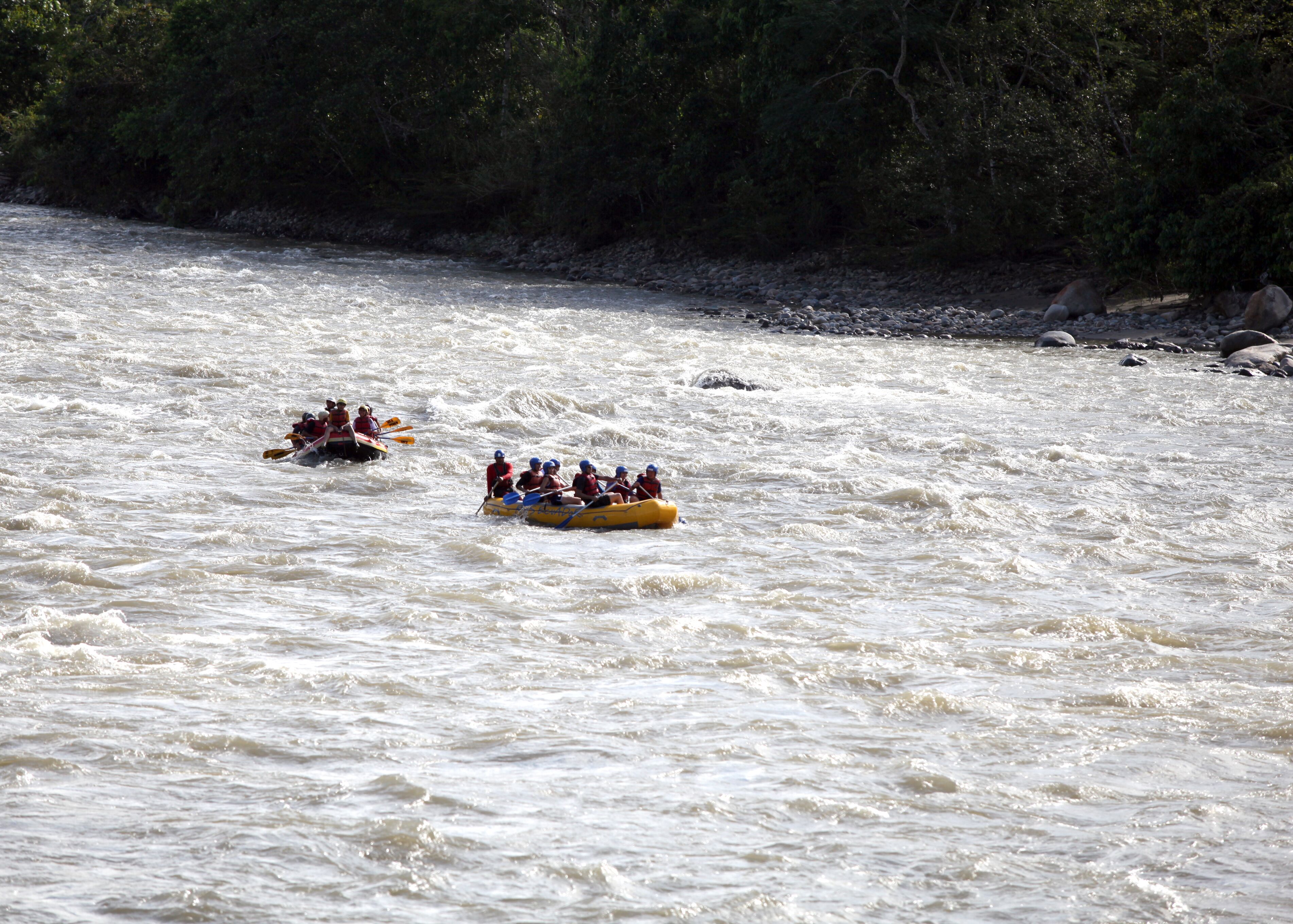 A group of people rafting down a river.