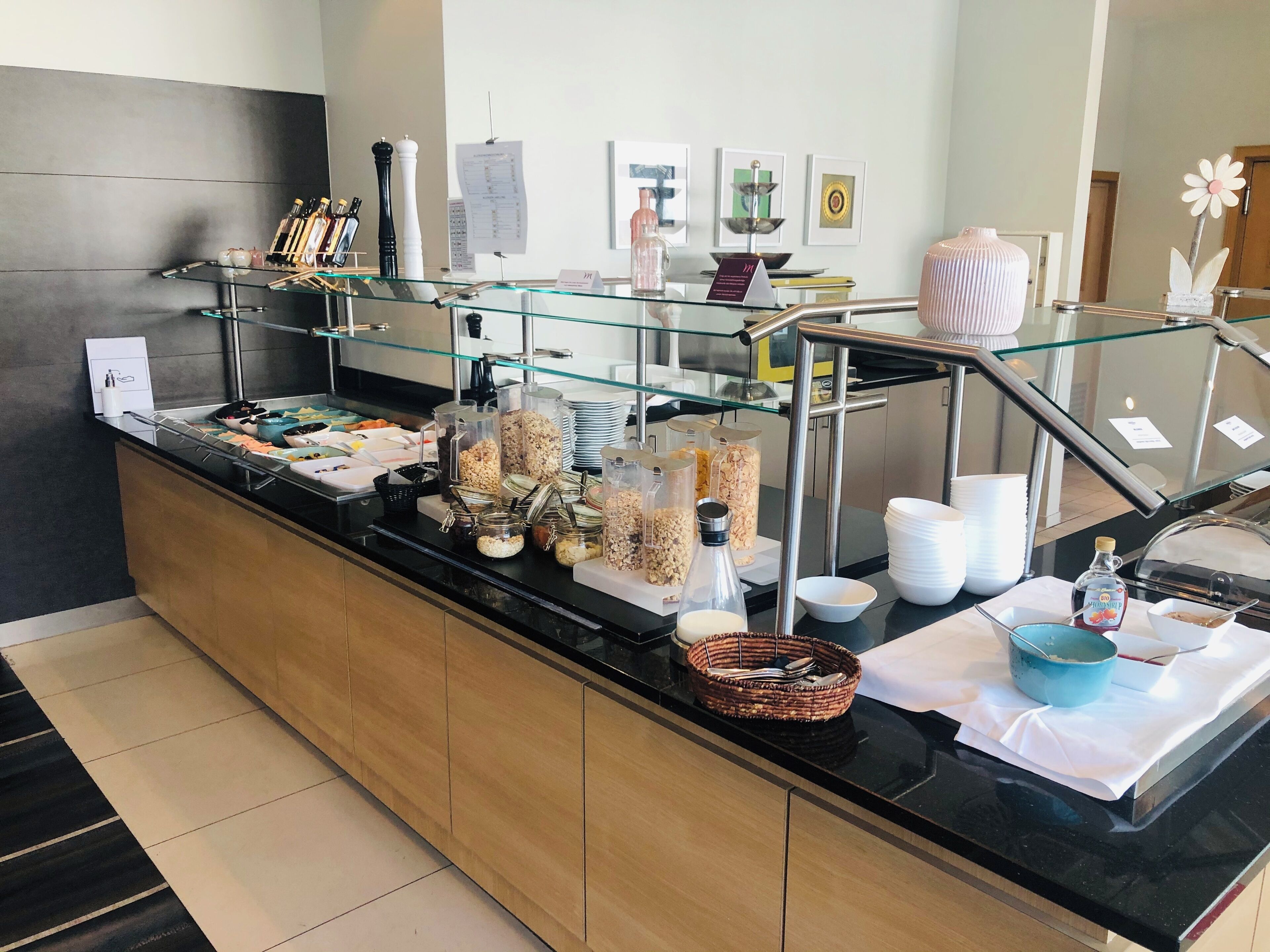 A buffet area with various food items and condiments.