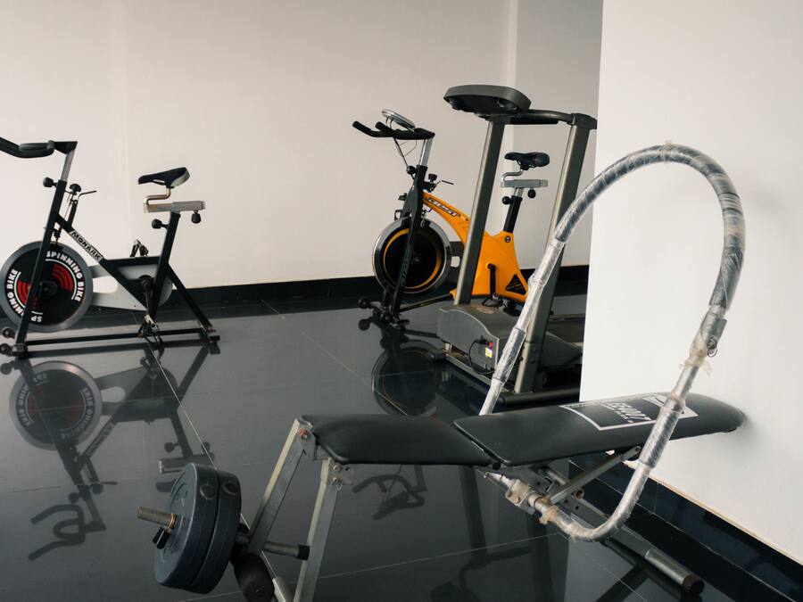 Un gimnasio con bicicletas estáticas y cinta de correr.