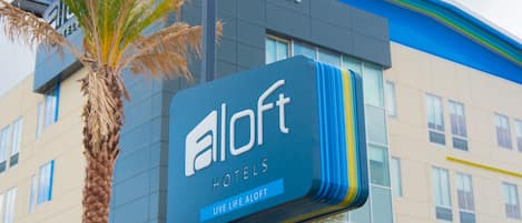 A hotel sign with the name 'aloft hotels' and the tagline 'live life aloft'.