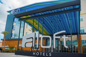 A modern hotel building with a prominent 'eLoft Hotels' sign. - Aloft by Marriott Corpus Christi (Corpus Christi)