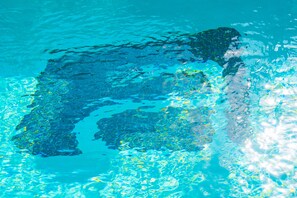 A clear view of a swimming pool with visible water patterns and reflections.