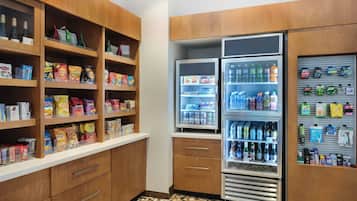 A well-organized pantry with shelves stocked with snacks, beverages, and condiments.