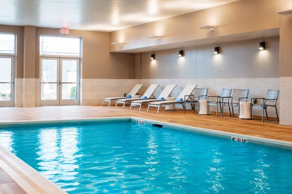 An indoor swimming pool with lounge chairs and a view of the outside. - Residence Inn by Marriott Boston Burlington (Burlington)