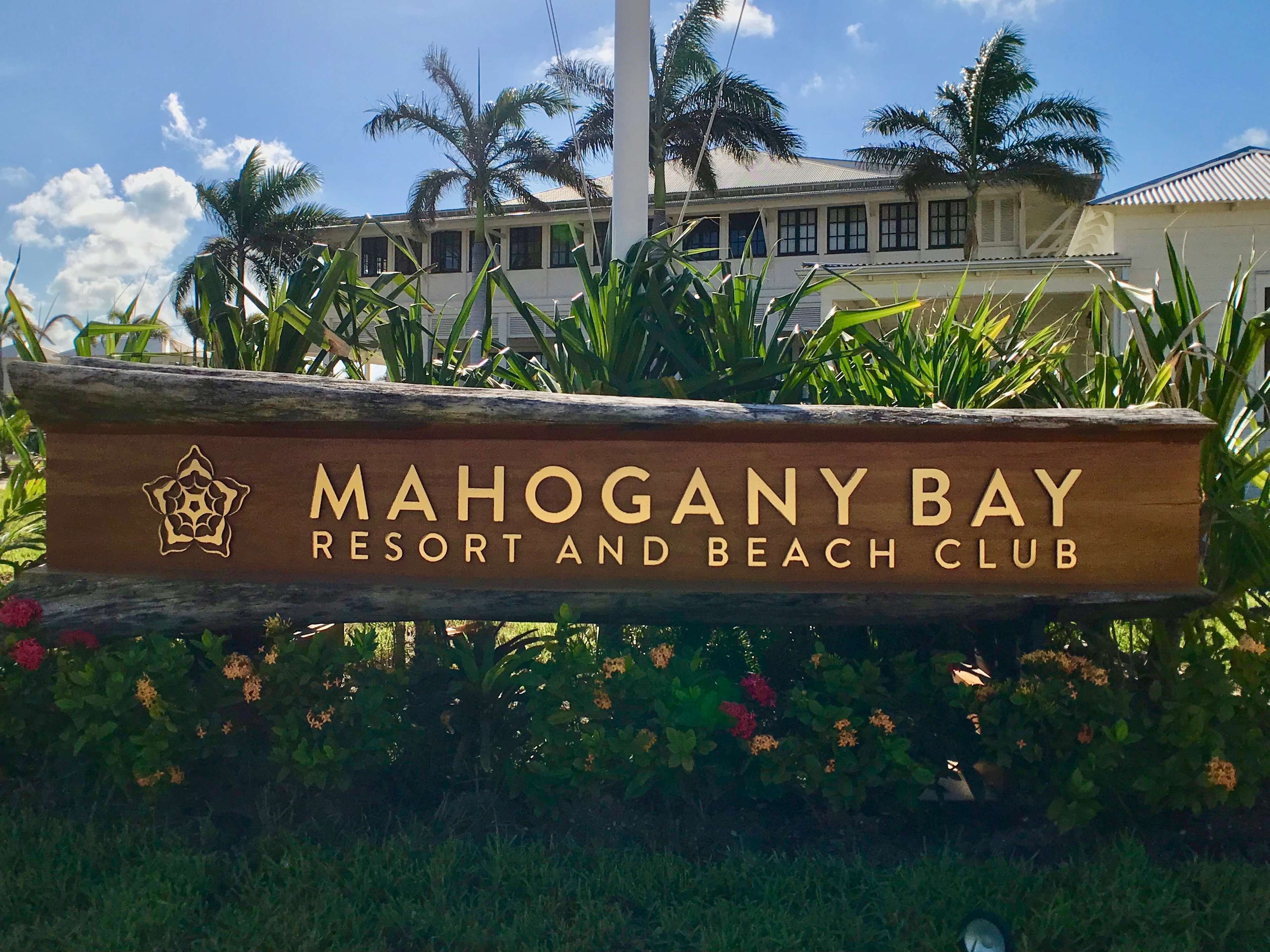 A sign for Mahogany Bay Resort and Beach Club.