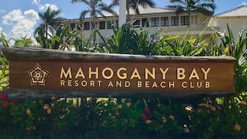 A sign for Mahogany Bay Resort and Beach Club.