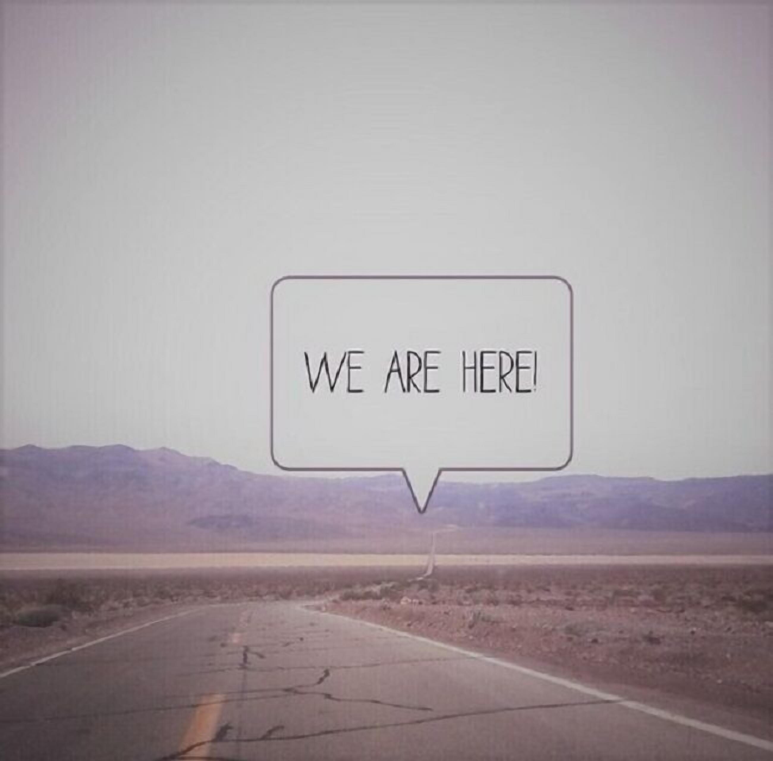 A road with a speech bubble saying "WE ARE HERE!".