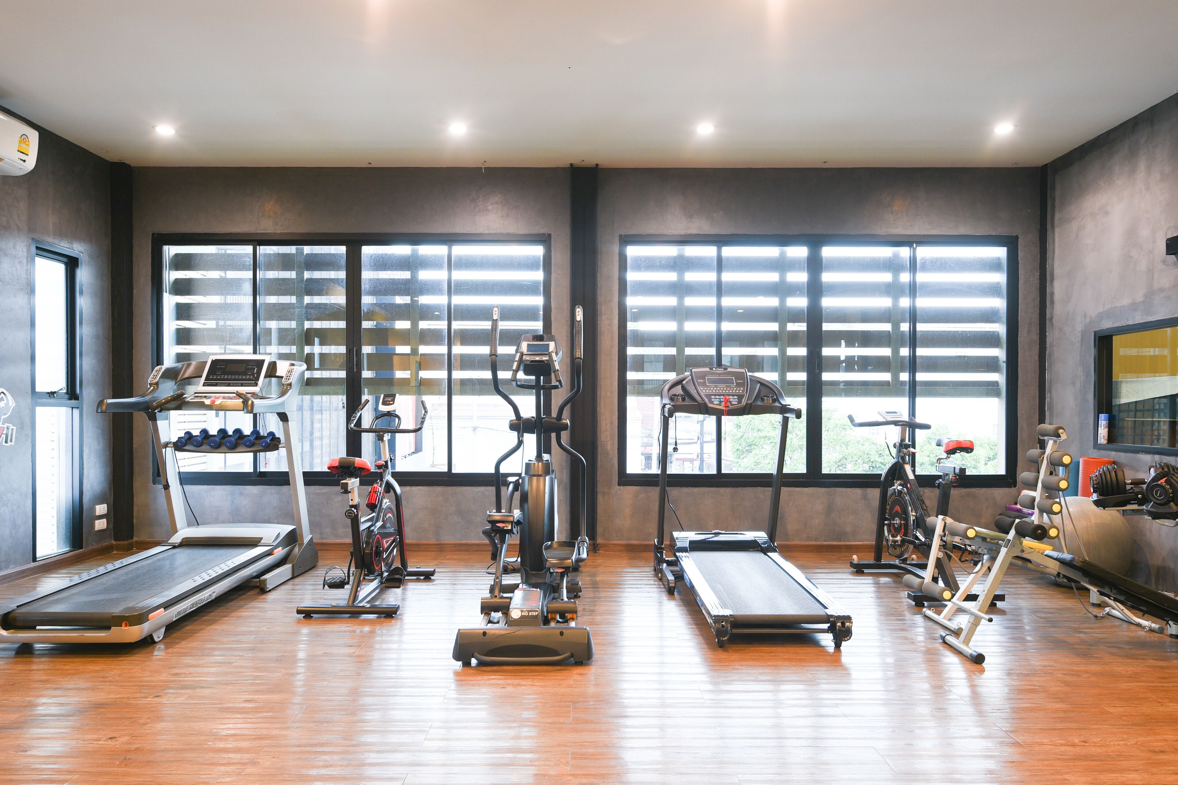 A gym with treadmills, elliptical machines, and weight equipment.