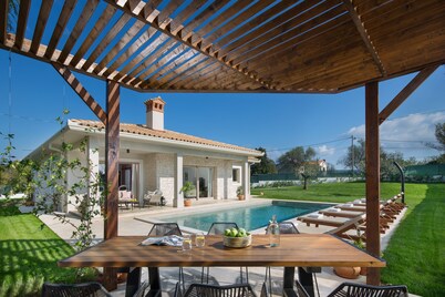 Mediterranean villa with large private pool and garden, ideal for relaxing.