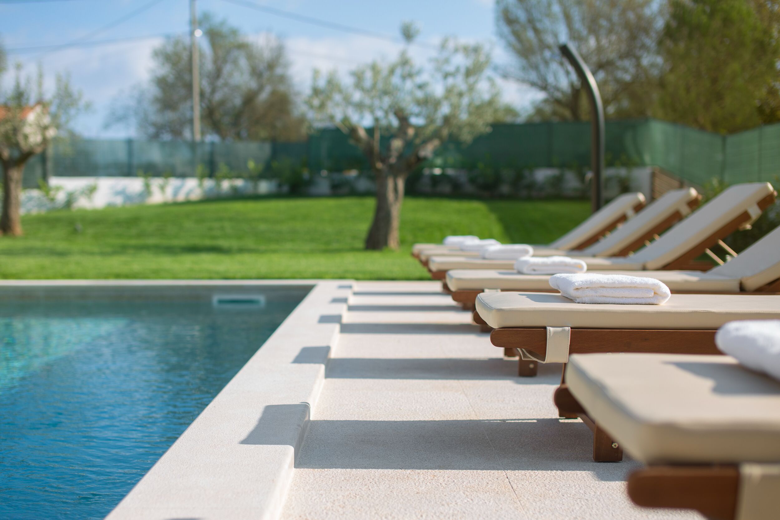 A poolside area with lounge chairs and towels.