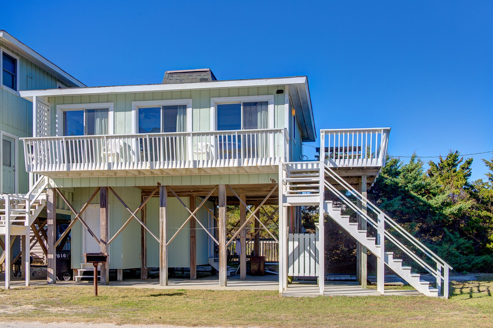 A two-story house with a balcony and a staircase leading to the upper level.