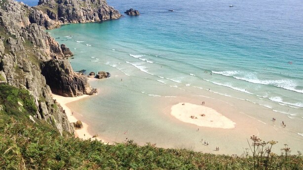 A coastal landscape with rocky cliffs, a sandy beach, and clear blue waters. - Delightful 300 year old cottage in quiet country lane (Crowlas)