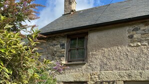 A stone house with a chimney, a window, and a door. - Delightful 300 year old cottage in quiet country lane (Crowlas)