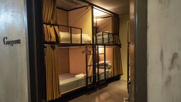 A bunk bed room with curtains and a sign that reads "Gorgeous".