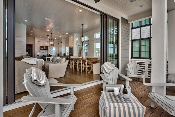 A spacious living area with a dining table, multiple chairs, and a cozy seating arrangement.