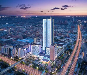 A high-rise hotel with a modern design, surrounded by a busy urban area with visible roads and other buildings. - Regal Palace Hotel  (Dongguan)