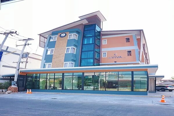 A multi-story hotel with a modern design, featuring a prominent blue and orange facade, large glass windows, and a visible sign for 'VIVA'.