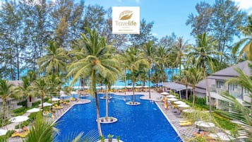 Relax by the resort's central pool surrounded by palm trees and lounge areas.