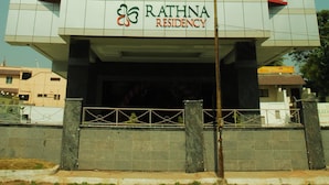 A modern building with a grid-like facade and the name "RATHNA RESIDENCY" displayed prominently. - Rathna Residency (Coimbatore)