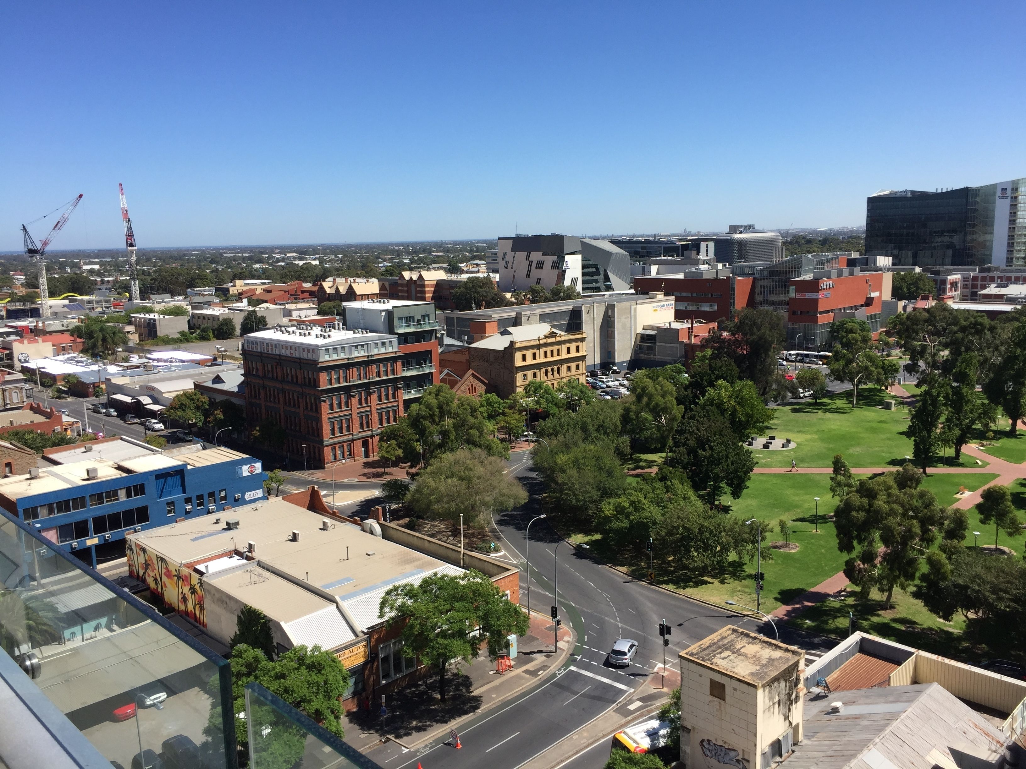 A cityscape with various buildings, roads, and greenery.